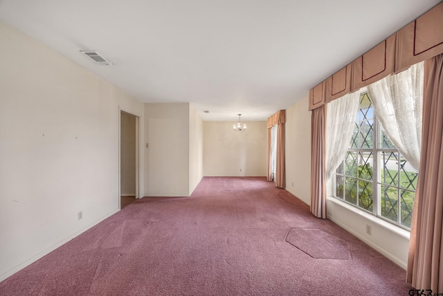 unfurnished room with carpet flooring and a notable chandelier