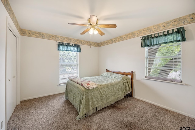 carpeted bedroom featuring ceiling fan and a closet