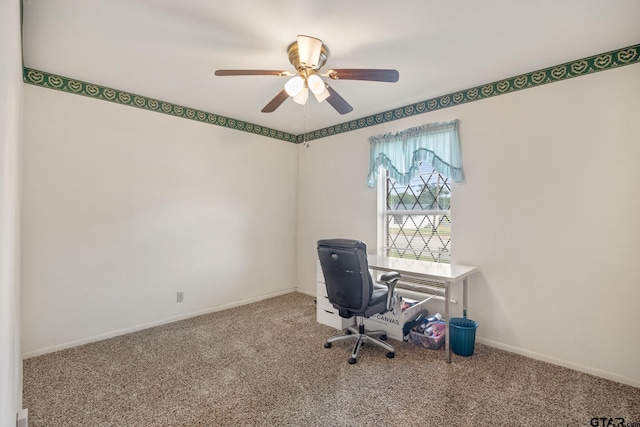 unfurnished office featuring ceiling fan and carpet floors