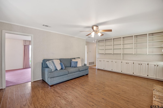 living room featuring ceiling fan, light hardwood / wood-style flooring, and crown molding