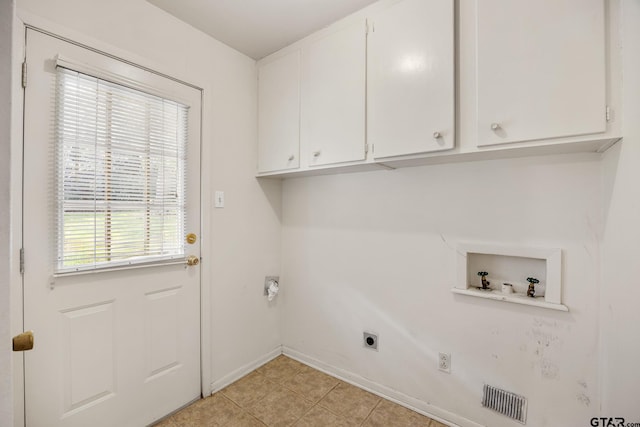 laundry area featuring hookup for an electric dryer, washer hookup, cabinets, and light tile patterned floors