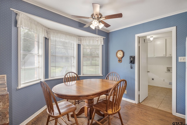 dining room with light hardwood / wood-style floors, ceiling fan, and ornamental molding