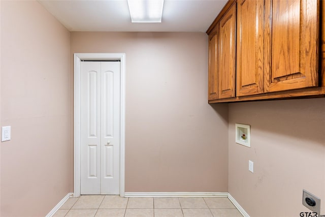 laundry area with hookup for a washing machine, cabinets, light tile patterned floors, and electric dryer hookup