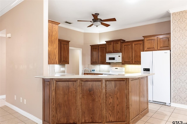 kitchen with light tile patterned floors, kitchen peninsula, backsplash, and white appliances