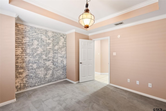 carpeted spare room featuring brick wall and crown molding