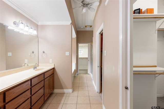 bathroom with tile patterned floors, vanity, a tub, ornamental molding, and ceiling fan