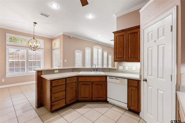 kitchen with light tile patterned floors, white dishwasher, ornamental molding, pendant lighting, and sink