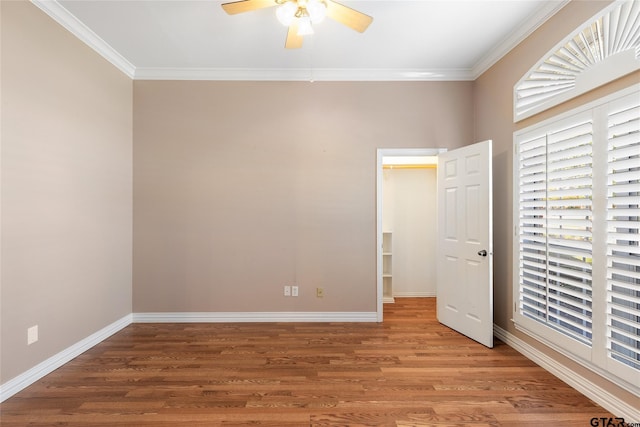 unfurnished bedroom with ceiling fan, hardwood / wood-style flooring, and crown molding