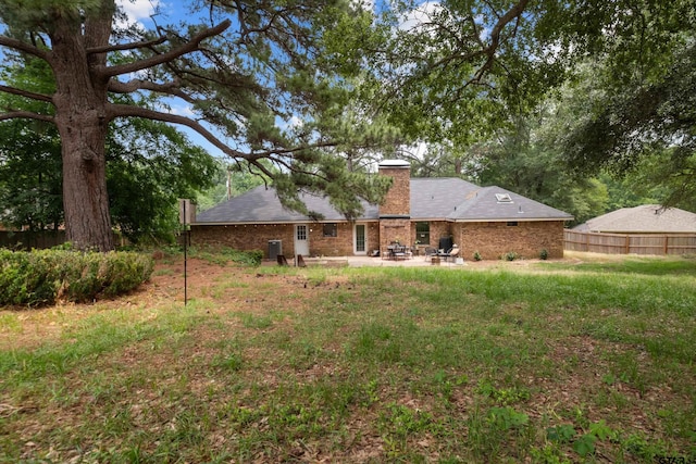 9331 Londonderry Dr, Tyler, TX 75703 - rear view of house featuring a patio area, a chimney, and brick siding