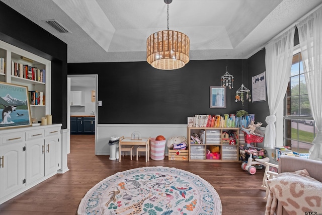 9331 Londonderry Dr, Tyler, TX 75703 - playroom with a raised ceiling, a chandelier, and wood finished floors