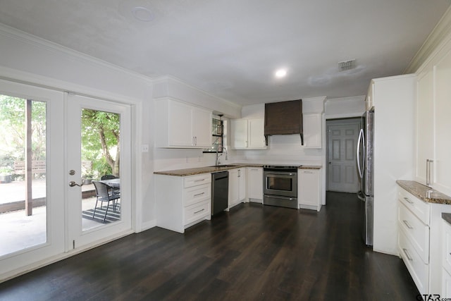 18751 Ridgeline, Tyler, TX 75703 - kitchen with stainless steel appliances, custom range hood, dark wood-type flooring, white cabinetry, and ornamental molding