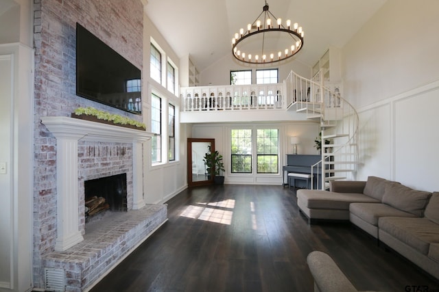 18751 Ridgeline, Tyler, TX 75703 - living area with a fireplace, a decorative wall, a chandelier, high vaulted ceiling, and wood finished floors