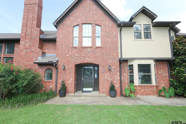 18751 Ridgeline, Tyler, TX 75703 - view of front facade with a chimney, stucco siding, and brick siding
