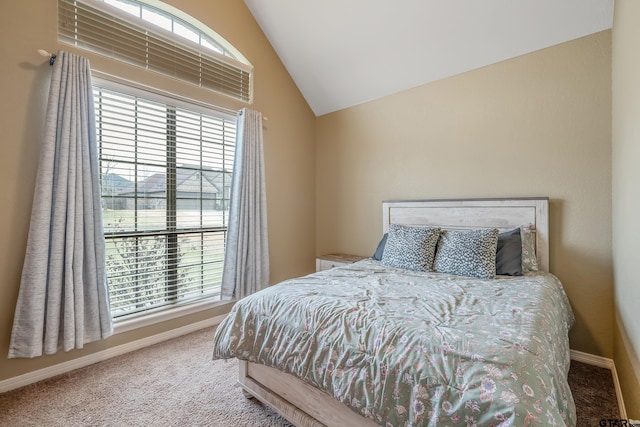 carpeted bedroom featuring lofted ceiling and baseboards