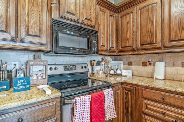 kitchen featuring brown cabinets, electric range, black microwave, and tasteful backsplash