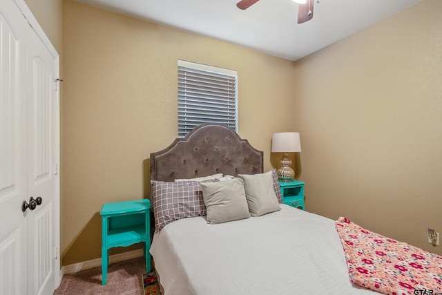 carpeted bedroom with a ceiling fan and baseboards