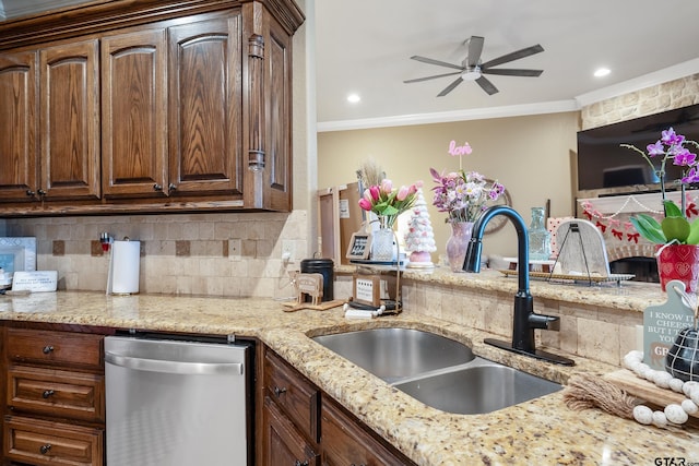 kitchen featuring light stone counters, a sink, ornamental molding, stainless steel dishwasher, and backsplash