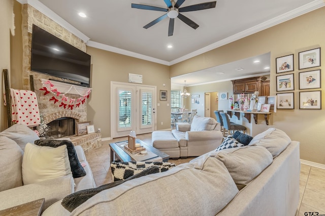 living area featuring a fireplace, light tile patterned floors, ornamental molding, baseboards, and ceiling fan with notable chandelier