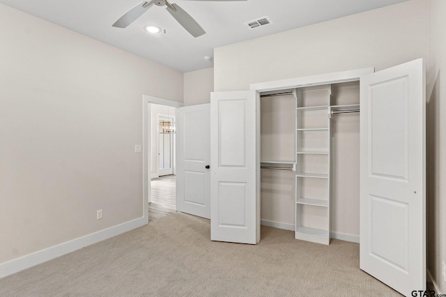 unfurnished bedroom with ceiling fan, a closet, and light colored carpet