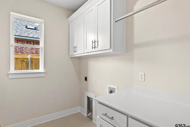 laundry area with hookup for a washing machine, electric dryer hookup, and cabinets