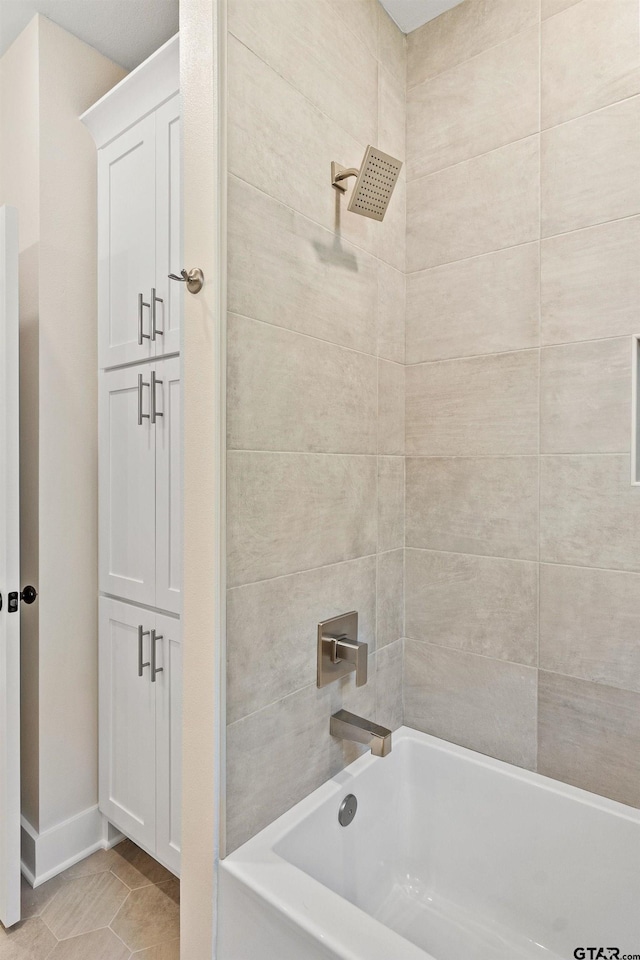 bathroom featuring tile patterned flooring and tiled shower / bath combo