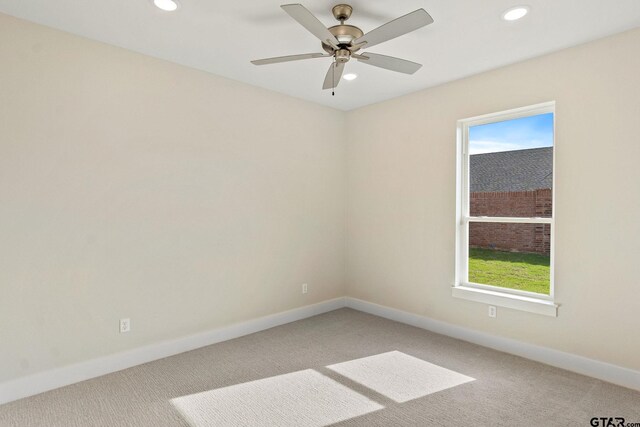 empty room featuring ceiling fan and carpet floors