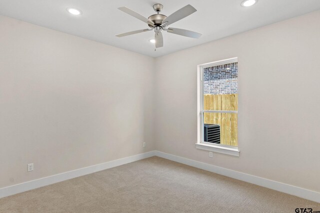 empty room featuring ceiling fan and carpet floors