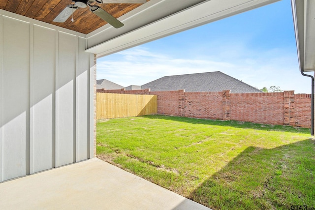 view of yard featuring ceiling fan and a patio