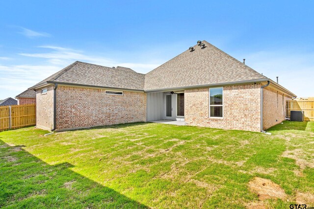 rear view of house featuring a patio area and a yard