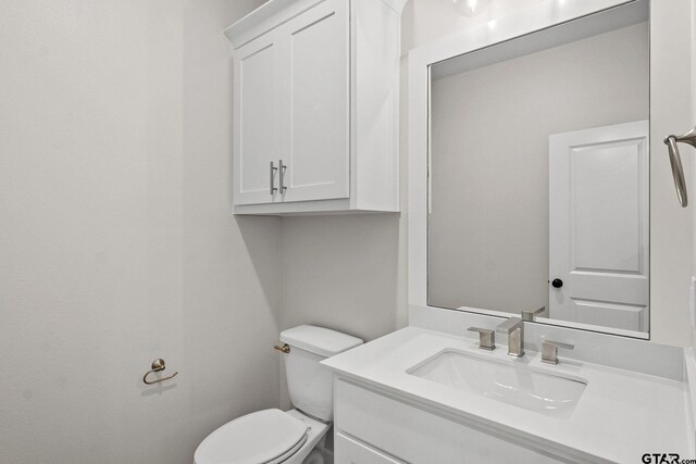 bathroom with toilet and vanity