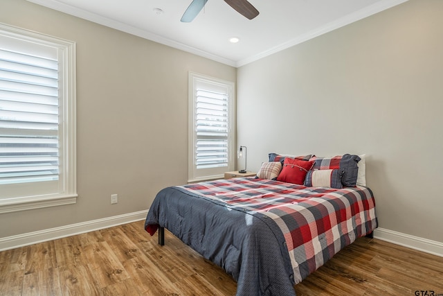 bedroom featuring crown molding, hardwood / wood-style flooring, and ceiling fan