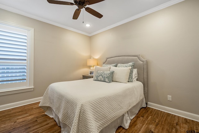 bedroom featuring ceiling fan, dark hardwood / wood-style floors, and ornamental molding