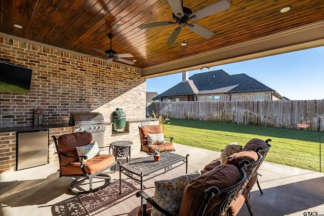 view of patio with an outdoor kitchen, area for grilling, ceiling fan, and an outdoor living space