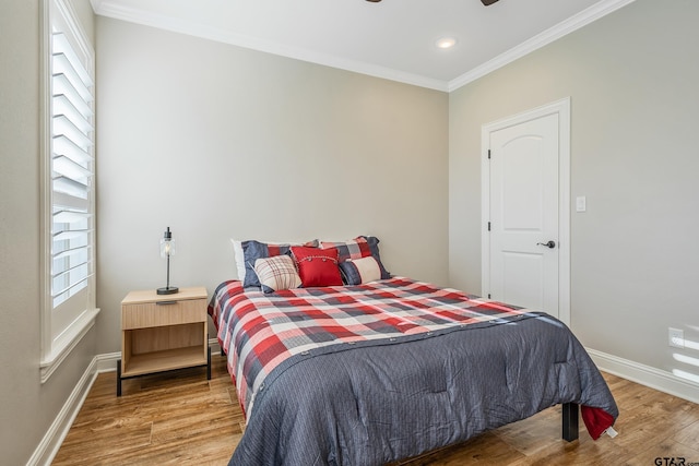 bedroom with hardwood / wood-style flooring and crown molding