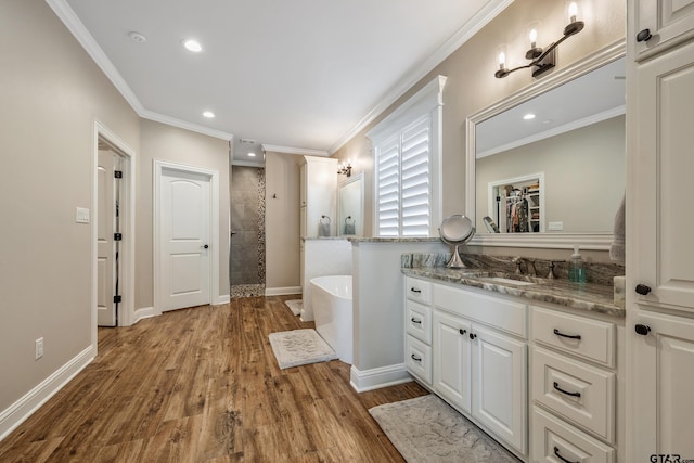 bathroom featuring ornamental molding, wood-type flooring, vanity, and independent shower and bath