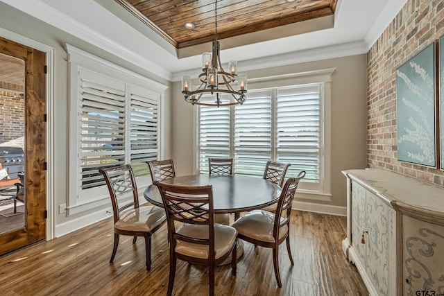 dining area with crown molding, a raised ceiling, an inviting chandelier, dark wood-type flooring, and wooden ceiling