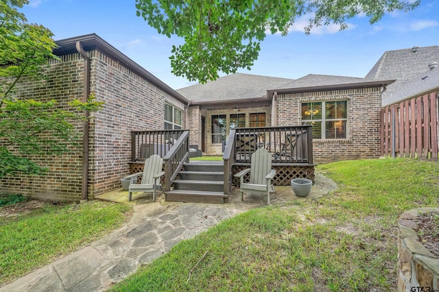 7216 Princedale, Tyler, TX 75703 - rear view of property featuring brick siding, a deck, and a shingled roof