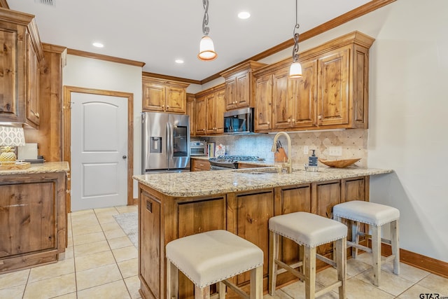 7216 Princedale, Tyler, TX 75703 - kitchen featuring appliances with stainless steel finishes, a peninsula, crown molding, light stone counters, and brown cabinetry