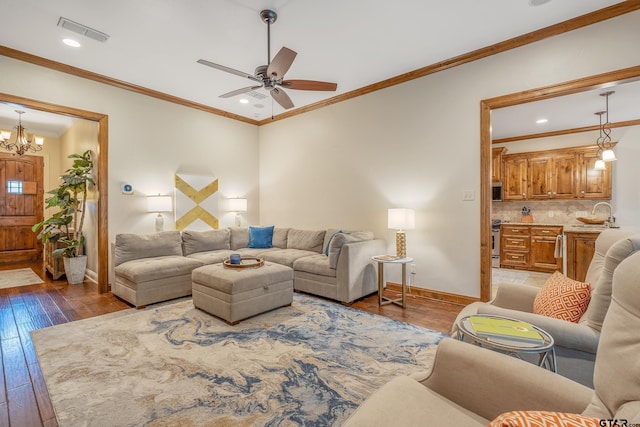 7216 Princedale, Tyler, TX 75703 - living room featuring hardwood / wood-style flooring, ceiling fan, crown molding, recessed lighting, and a chandelier