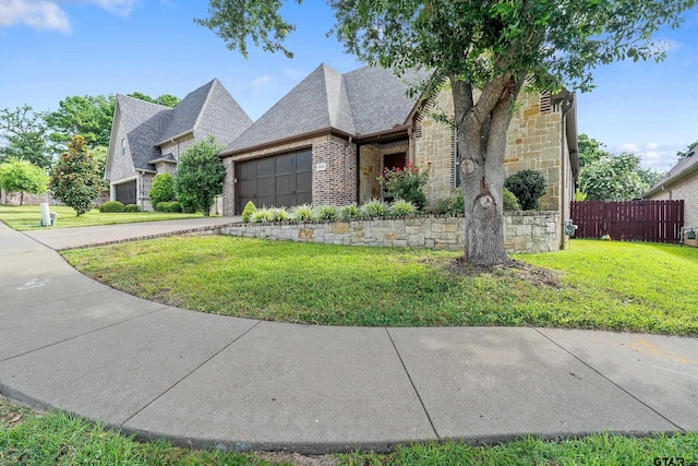 7216 Princedale, Tyler, TX 75703 - view of front of property featuring an attached garage, concrete driveway, stone siding, brick siding, and a shingled roof