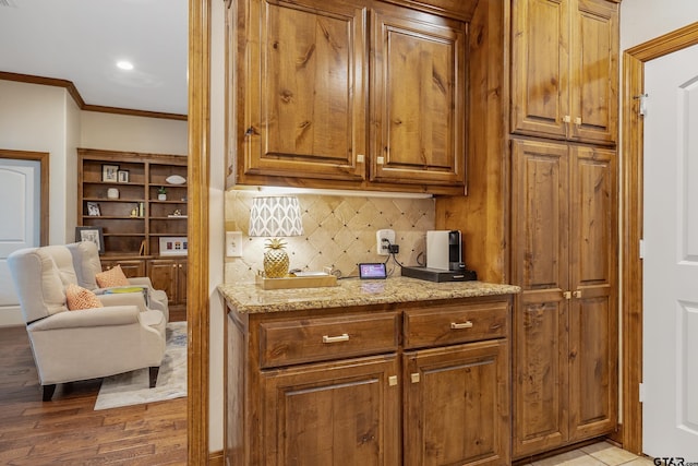 7216 Princedale, Tyler, TX 75703 - kitchen with ornamental molding, decorative backsplash, brown cabinets, light stone countertops, and recessed lighting