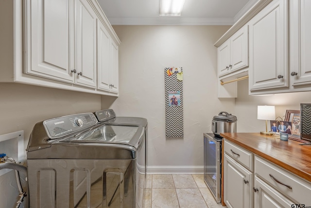 7216 Princedale, Tyler, TX 75703 - washroom featuring cabinet space, washer and dryer, and ornamental molding