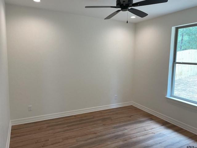 spare room with hardwood / wood-style flooring and ceiling fan