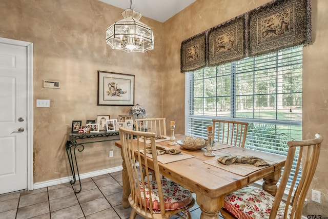 18050 Deer Trl, Flint, TX 75762 - tiled dining area featuring a chandelier, a high ceiling, and baseboards