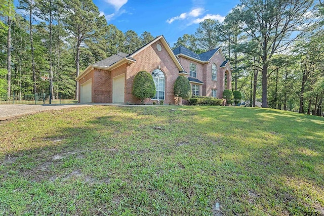 18050 Deer Trl, Flint, TX 75762 - view of front facade featuring a garage, brick siding, a front lawn, and concrete driveway