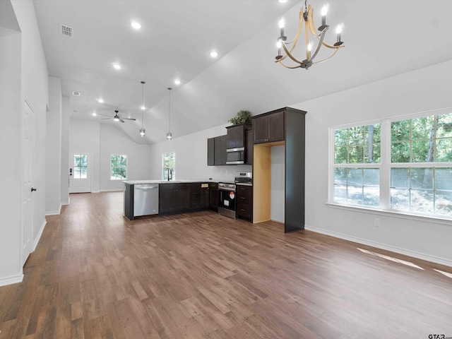 kitchen featuring kitchen peninsula, stainless steel appliances, dark brown cabinetry, sink, and dark hardwood / wood-style floors