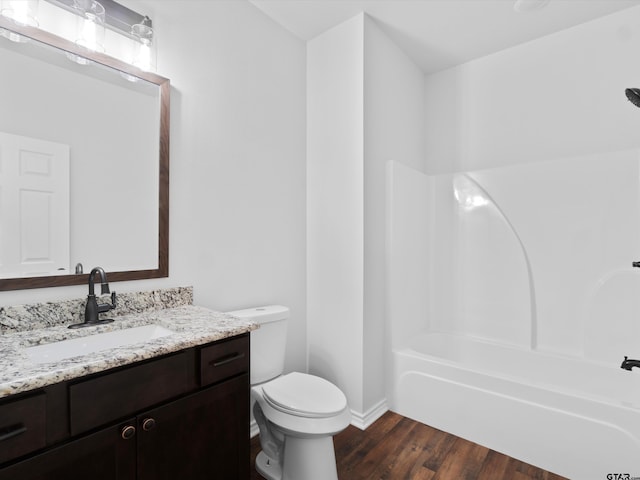 full bathroom with hardwood / wood-style floors, shower / bathing tub combination, vanity, and toilet