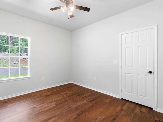 unfurnished room with ceiling fan and dark hardwood / wood-style flooring