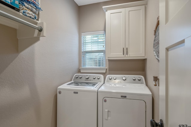 laundry area featuring cabinets and washing machine and dryer