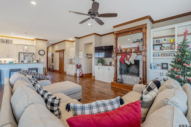 living room with ceiling fan, crown molding, and dark wood-type flooring